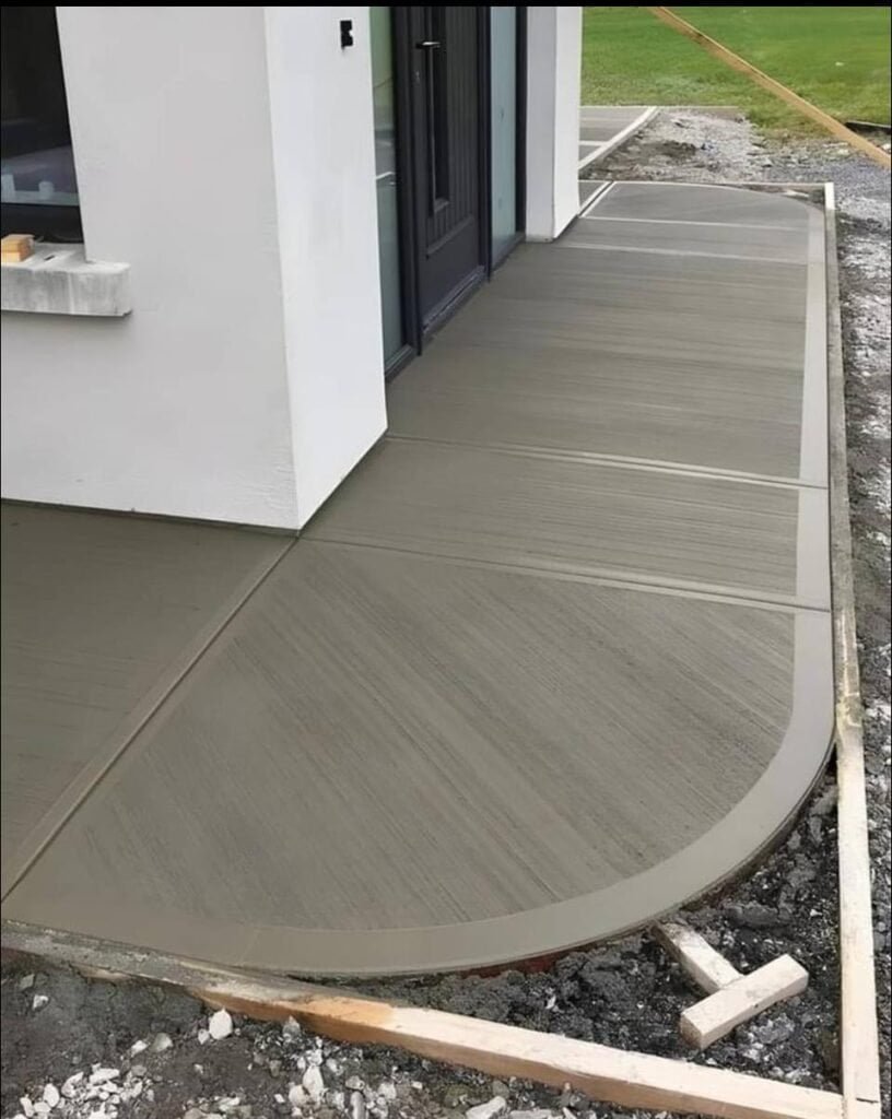 Concrete sidewalk with smooth finish around modern home.