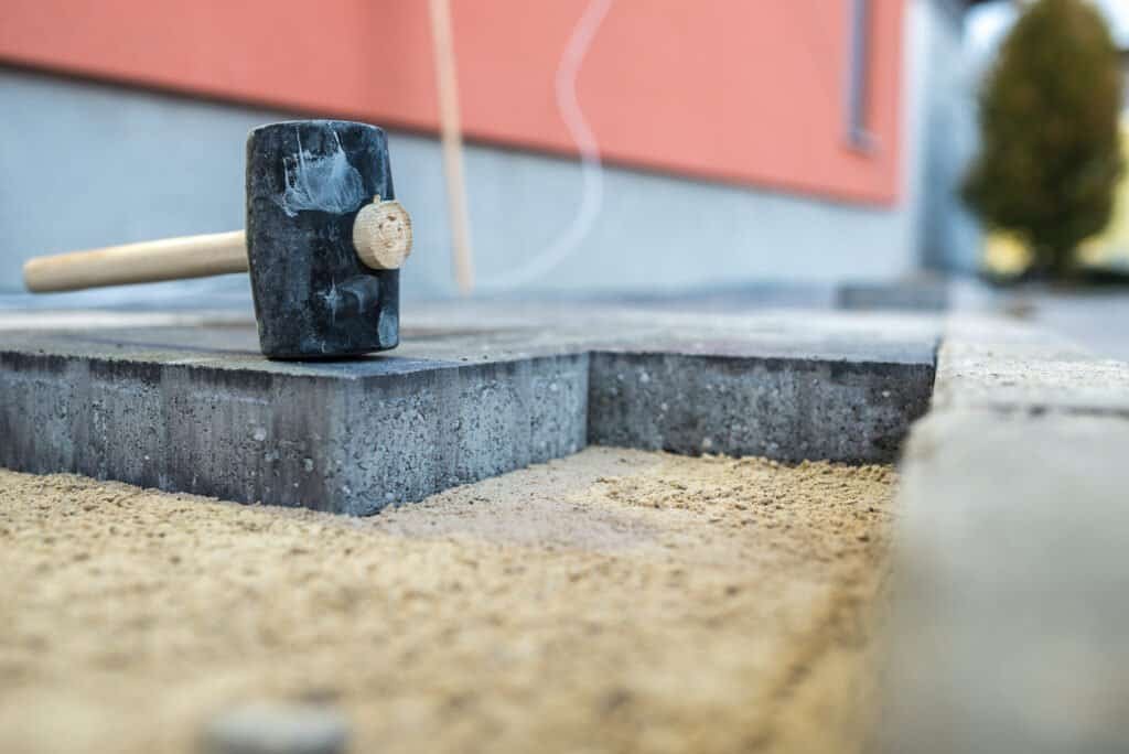 High-quality concrete paver with hammer tool for professional concrete work.