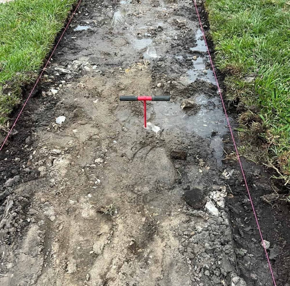 Cracked concrete driveway during demolition or repair process, showing ongoing construction work by West Dynamic Concrete Inc.