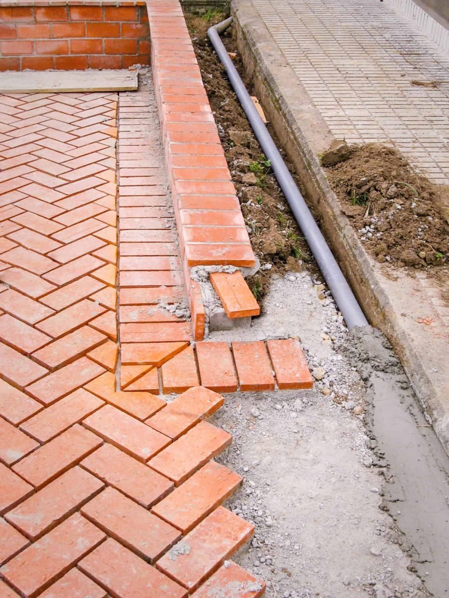 High-quality concrete driveway with brick edging, durable and stylish for residential properties.